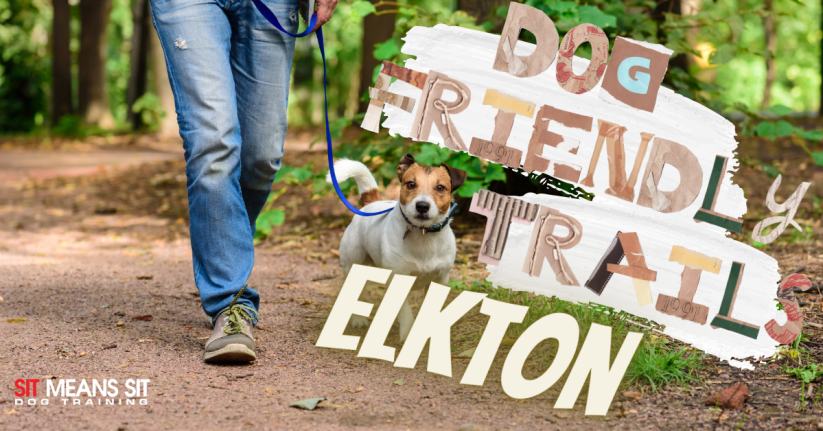 a person walking a dog on a leash with a sign that says dog friendly trail elkton